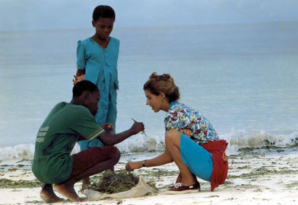 Walle with chirldren collecting sea weed